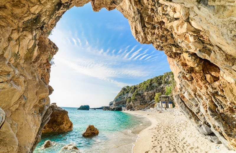 View of Mylopotamos beach through an arch-shaped rock formation