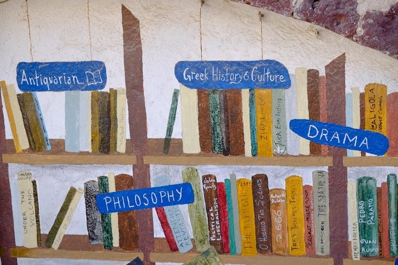 A painting of bookshelves in Atlantis Books, Oia