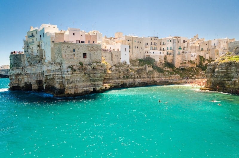 The buildings of Polignano a Mare tower over the sea
