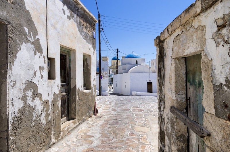 Rustic buildings and a domed church on Kimolos