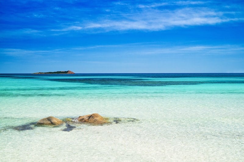 Shallow turquoise waters of Sardinia's Tahiti Beach.