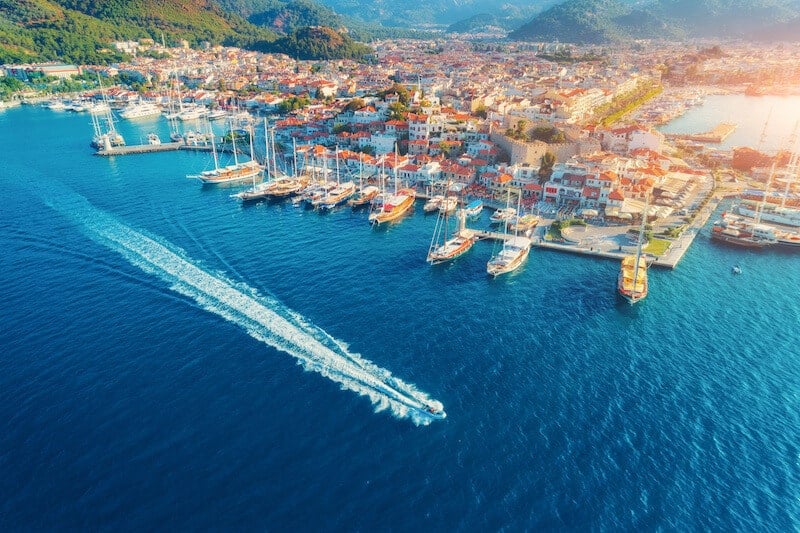 Aerial view of motorboat sailing out of Marmaris harbour.