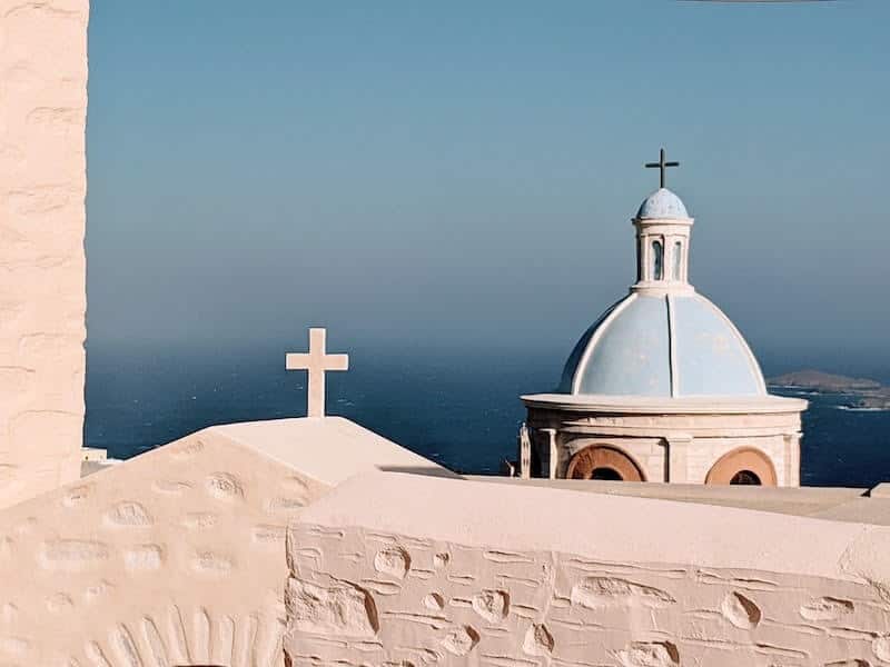 View across blue domed church rooftops to the sea from Ano Syros.