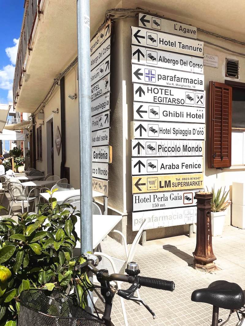Signposts for hotels, typical of Italian tourist hotspots.