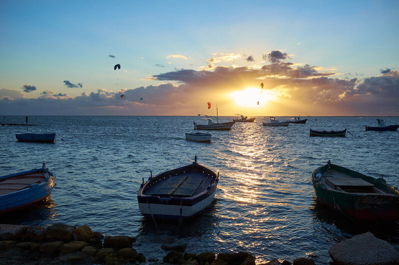 Kite surfers and fishing boats in Marsala.