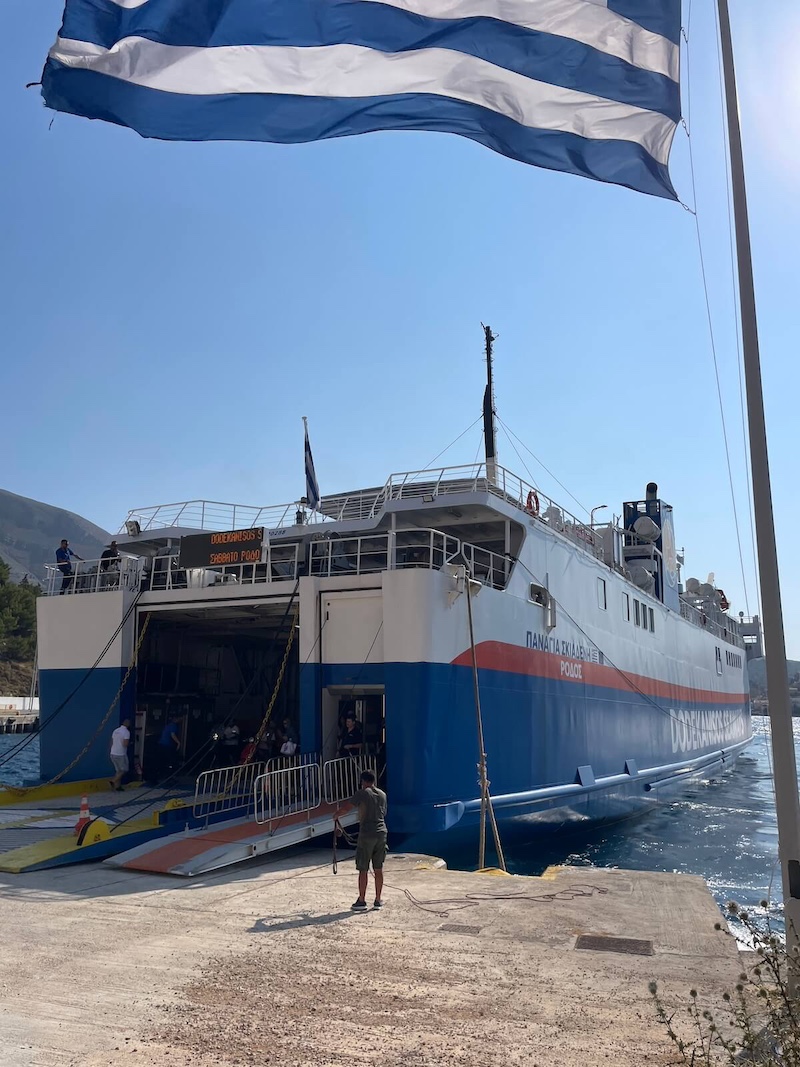 Dodekanisos Seaways Panagia Skiadenia ferry unloading at port, Greek flag in the foreground.