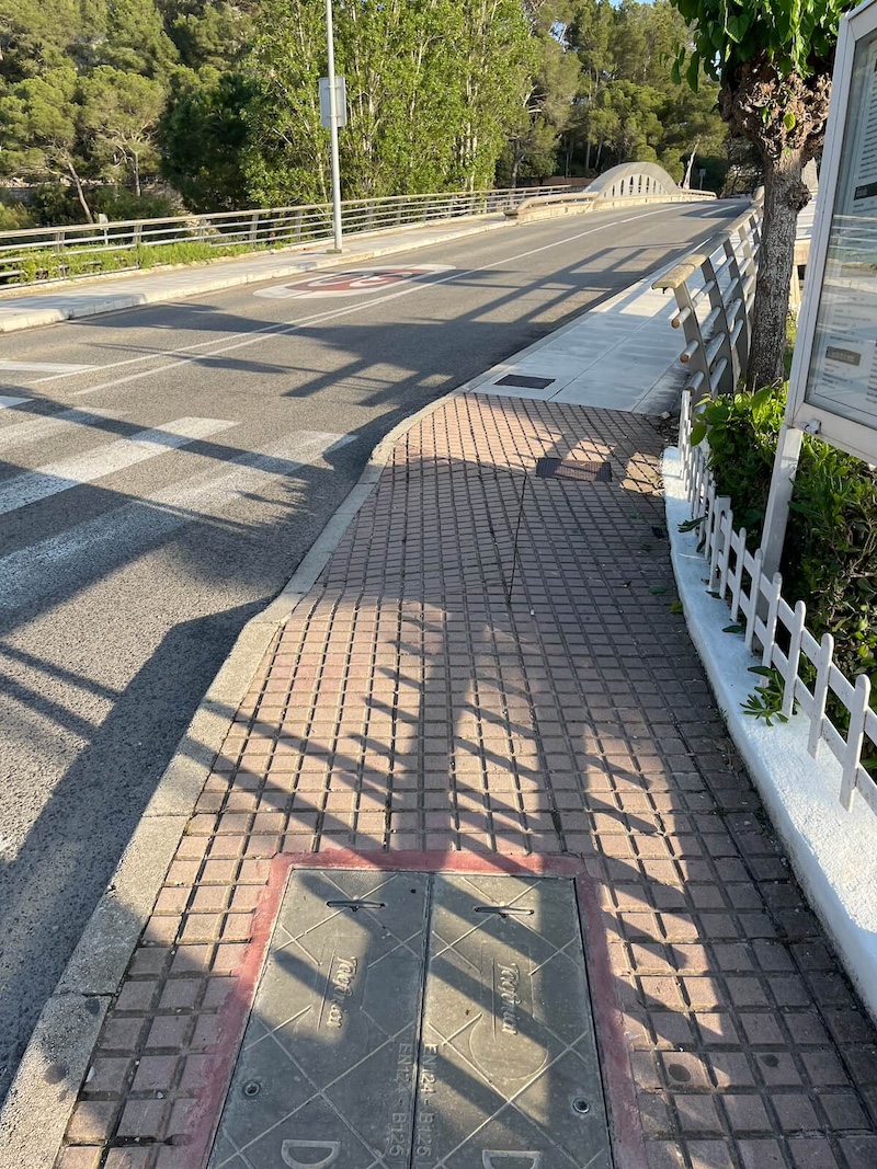 Sidewalk of the small bridge going across the river.