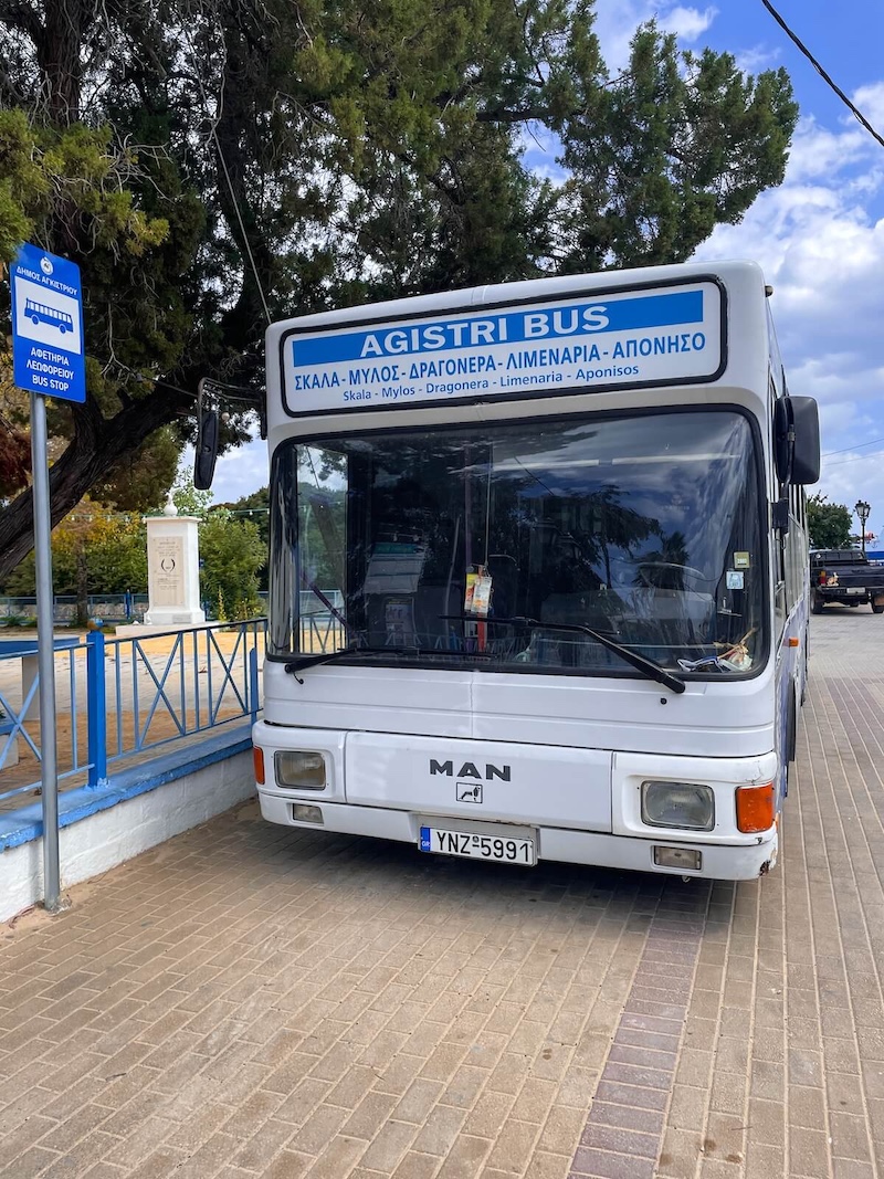 A bus at the bus stop outside the church in Skala.