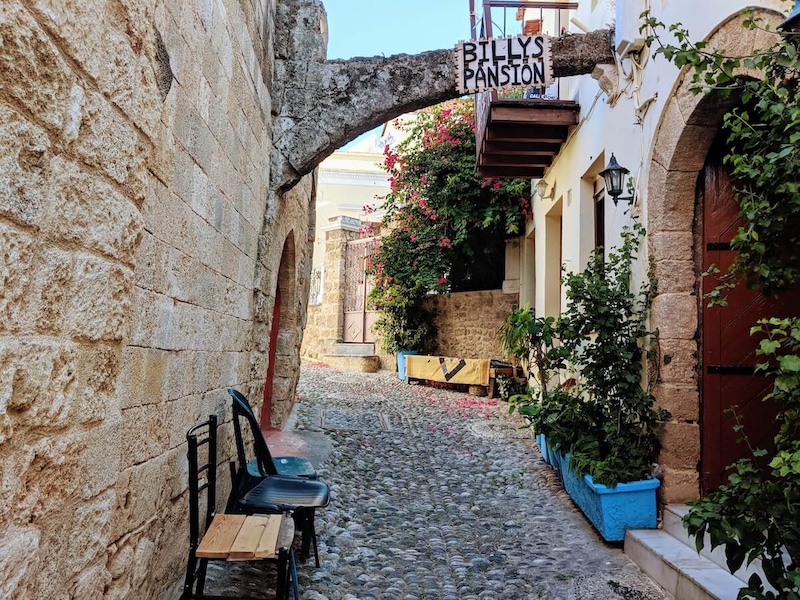 Cobbled medieval alleyway with an old archway in the Old Town.